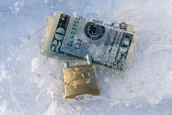 Frozen dollars with padlock